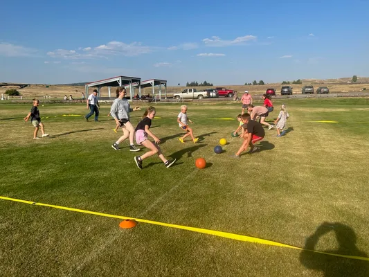 Youth racing to grab dogeballs.