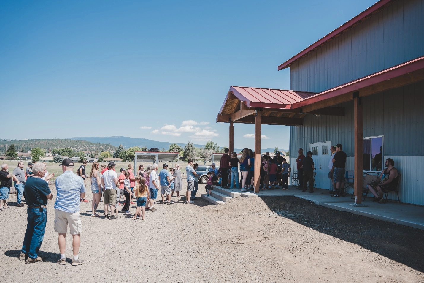 A large group of people leading up to the Epic Youth Center.