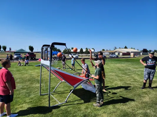 Youth playing with a basketball machine.