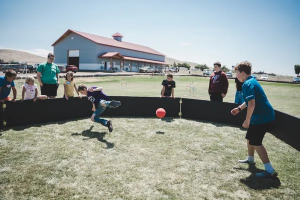 Youth playing with a ball in a ring.