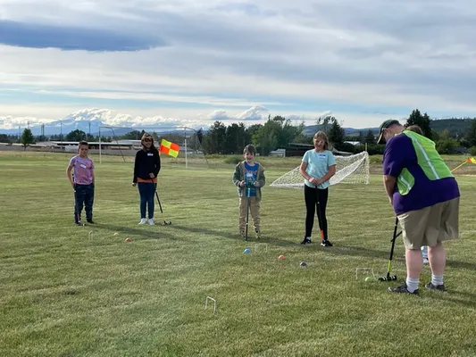 Youth outside playing croquet