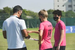 Youth speaking with a soccer coach