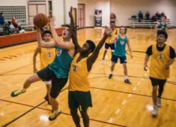 Youth playing basketball attempting a layup