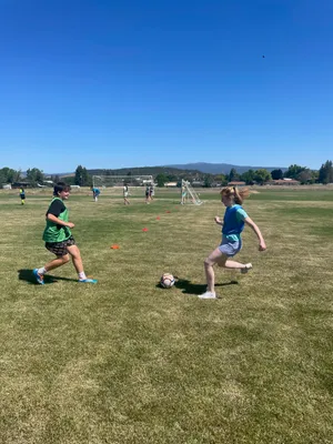 A youth preparing to kick a soccer ball.