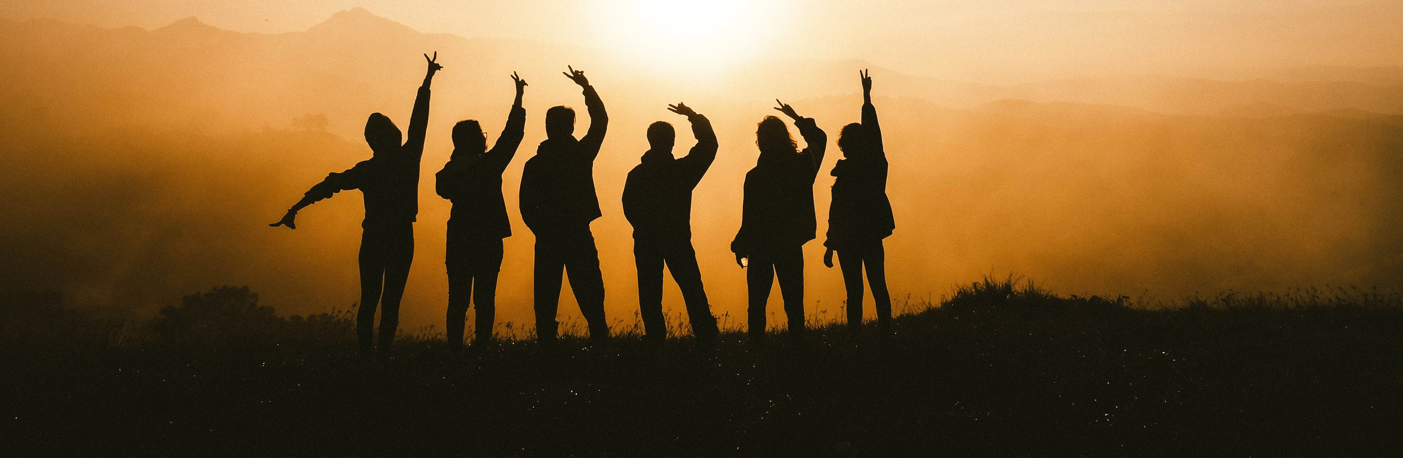 A group of youth starting into the sunset