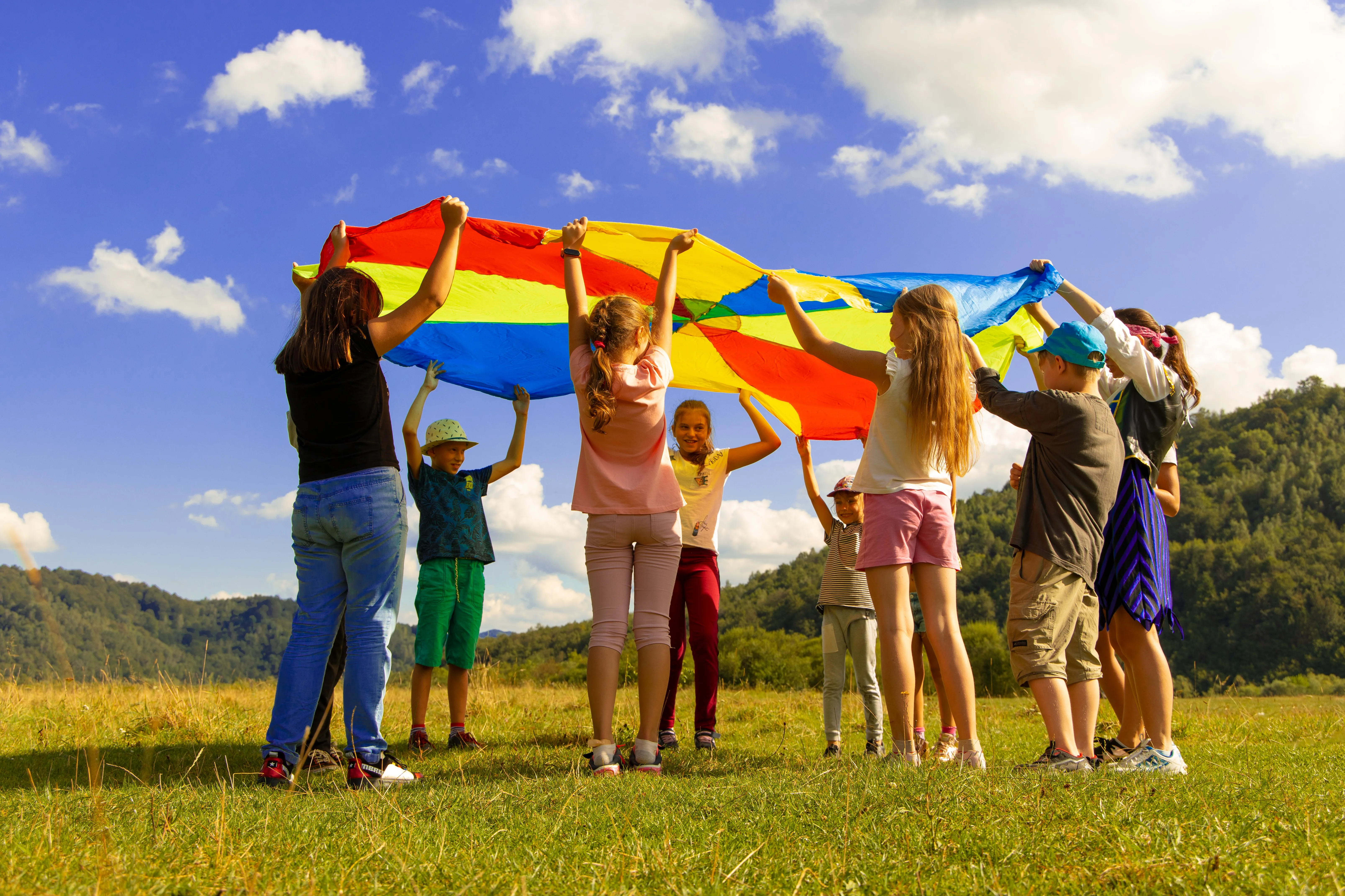 Youth playing with a brightly colored sheet