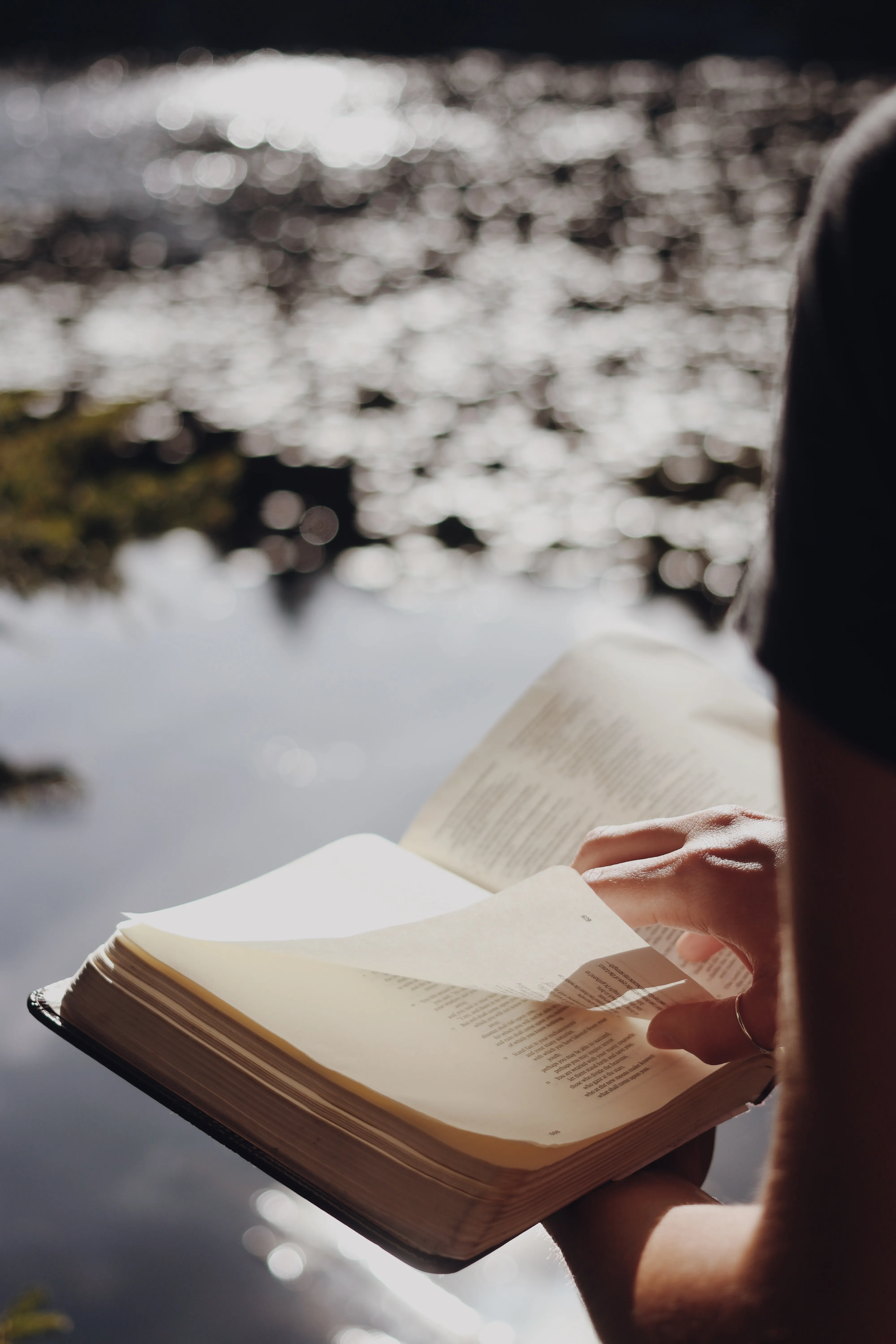 Reading the Bible by a lake