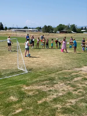 Youth in line playing with water.